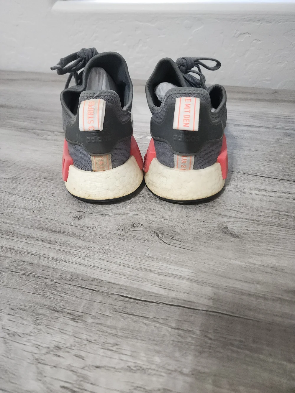 adidas Men’s Gray NMD_R1 Casual Sneaker with Red Accents